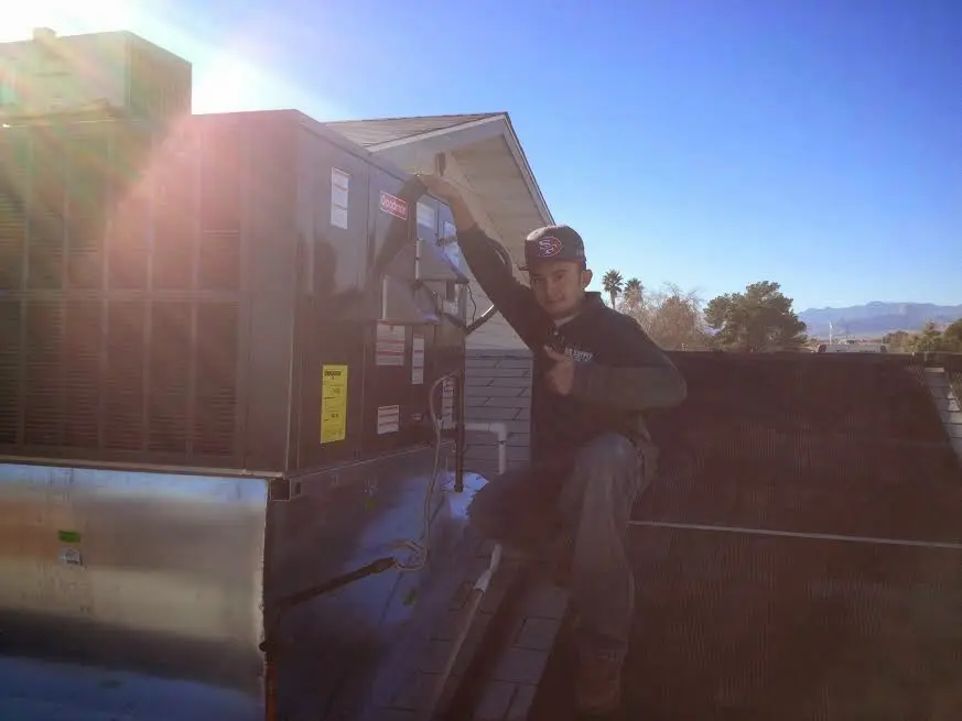 HVAC technician performing Air Duct Repair on a rooftop unit in Rancho Mission Viejo